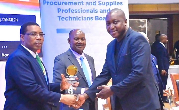 Minister of Finance Dr. Mwigulu Nchemba (left) presenting the scholarship award of the 14th Annual Conference of Procurement and Supply Specialists, Chief Executive Officer of the Business Registration and Licensing Agency (BRELA), Mr. Godfrey Nyaisa (right) International Conference Hall, Arusha (AICC).